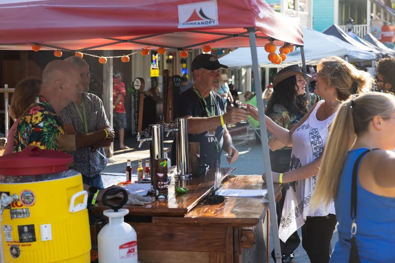 Representative of the Nevada County Brewers hands out a sample