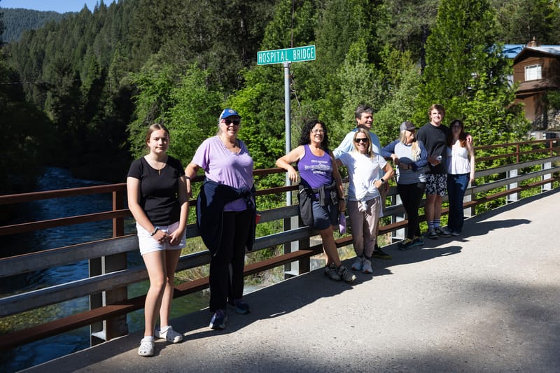 Walkers take a break on hospital bridge before continuing to Lavezzola Road.