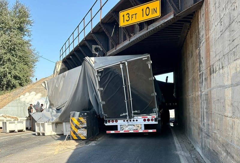 A closer view of the trailer under the railway bridge.