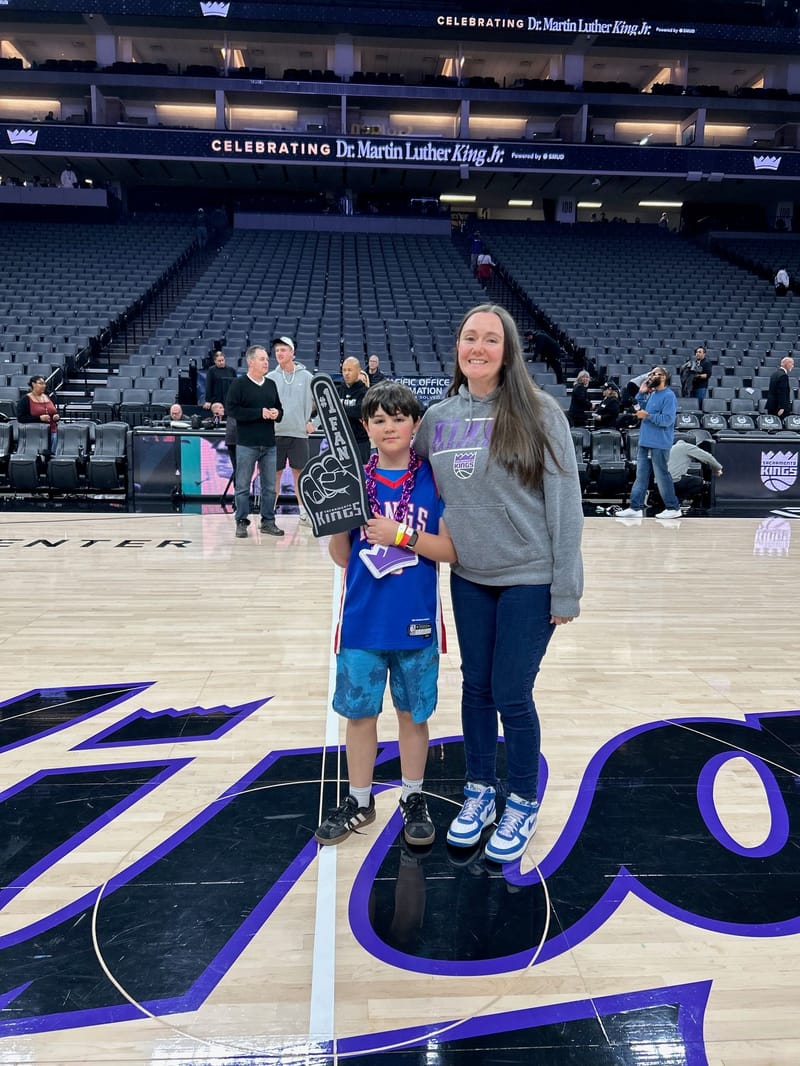 Left to right: Rudy and Tessa Jackson on the Golden One Center court on Sunday, January 18.