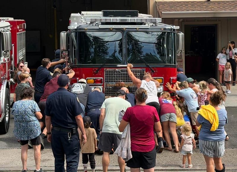 Firefighters and community members push Grass Valley’s new Engine 1 into Fire Station 1 during an August 7 ceremony.
