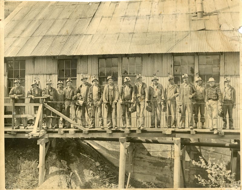 Sixteen to One Mine Crew, 1950. Milt Sanders is 4th from the right, wearing the overalls. Photo courtesy of undergroundgold.org.