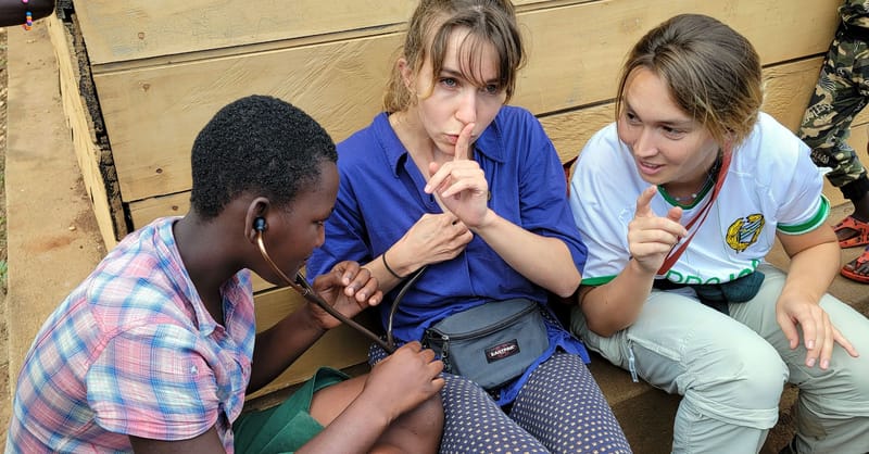 A 13-year-old Congolese refugee borrows a Swiss student’s stethoscope