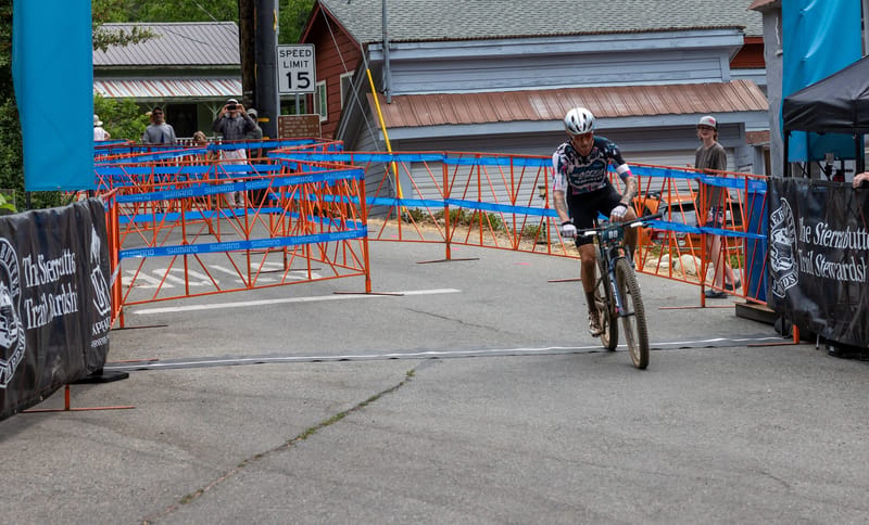 Swenson crosses the finish line in the cross-country race