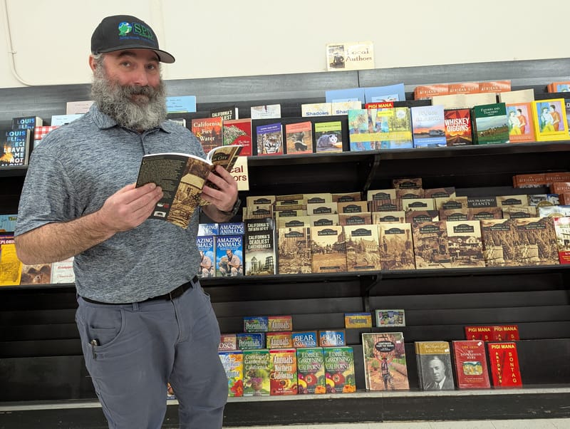 Ben Painter, store manager at Nevada City SPD Market, double checks the wide array of local material now featured on the former magazine rack.