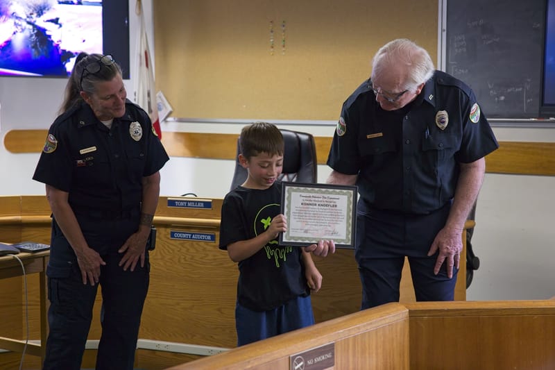 Knoefler receives a certificate of recognition from Downieville Fire Chief Robert Hall.