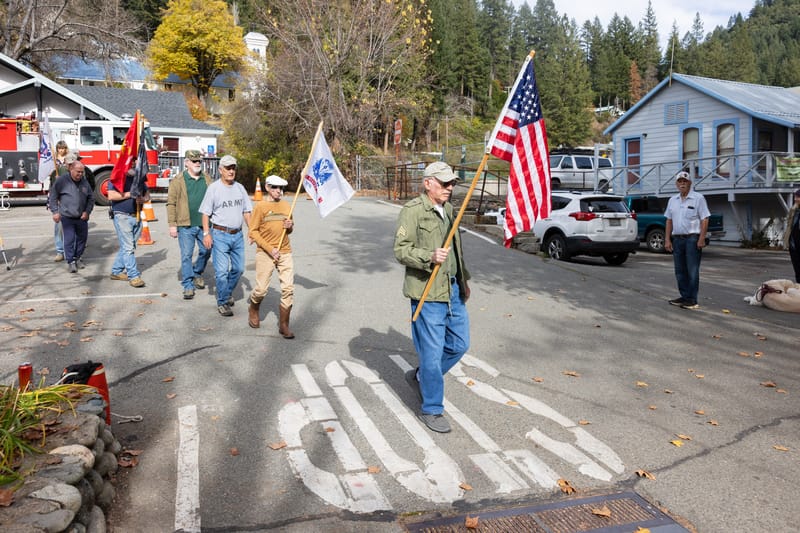 Gordon Bell leads the Veterans Day parade down Main Street toward the Community Hall.
