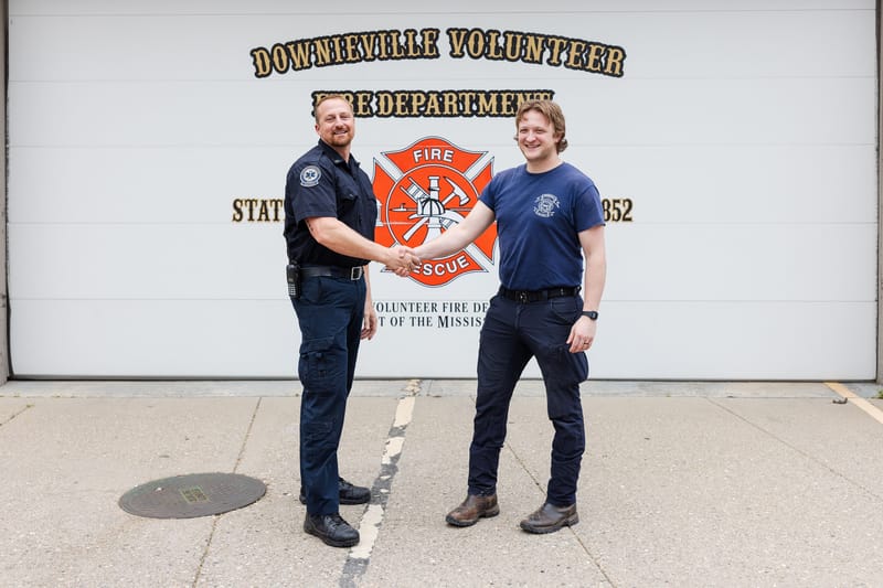 Incoming paramedic Cory Schiemann (left) and outgoing Tegan Harrington (right) in front of the Downieville Fire Station.