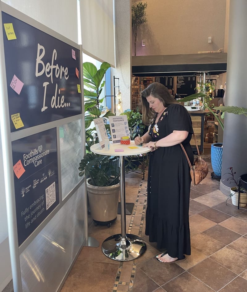Emily Turcios of Foothills Compassionate Care writes a response for the new installation. Photo: Foothills Compassionate Care.