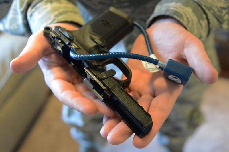 A handgun can be disarmed with a cable lock through its receiver, an acceptable form of “secure storage.” In this case, the gun is also partially disassembled.