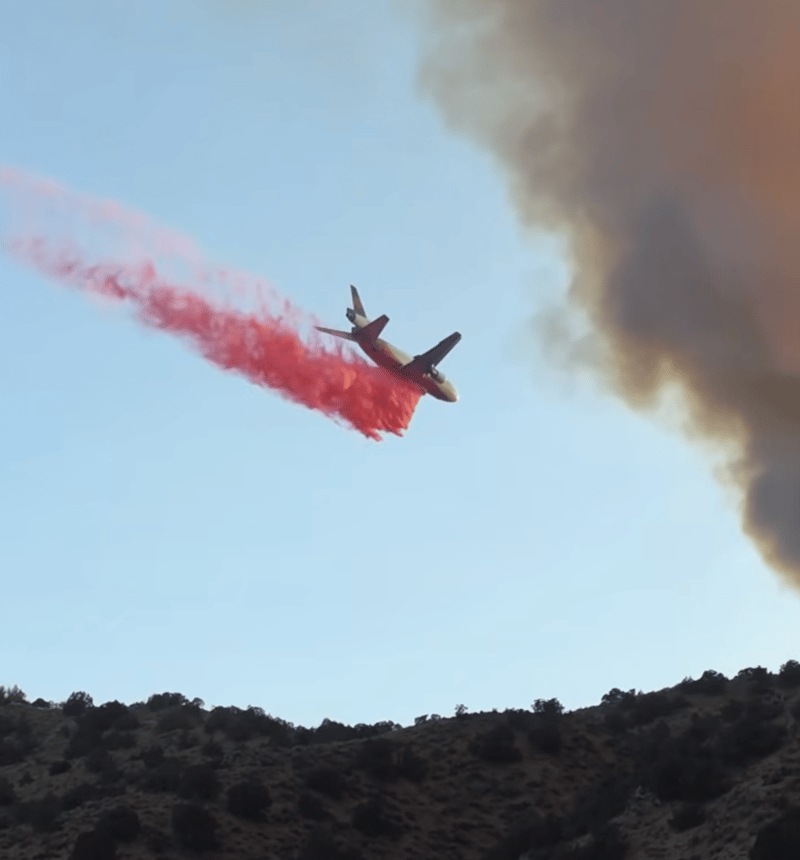 An air tanker drops fire retardant on Sunday.