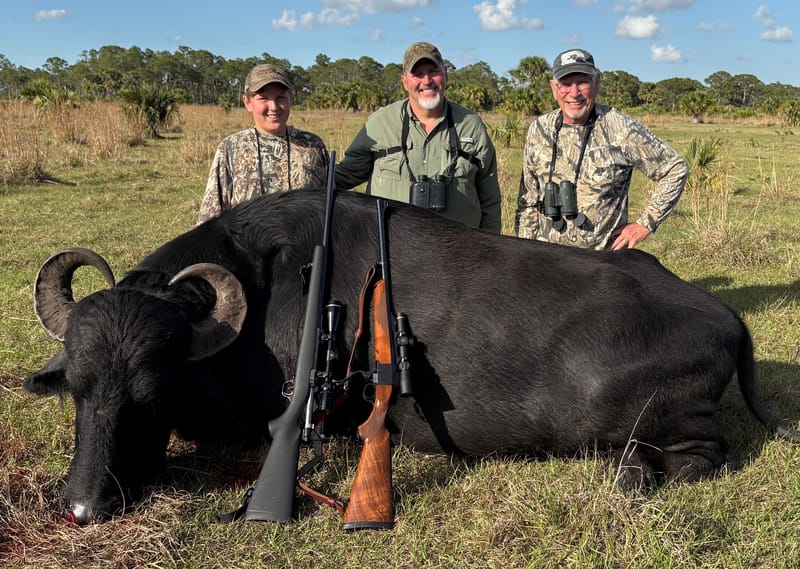 Dominic with his father and grandfather and their water buffalo.