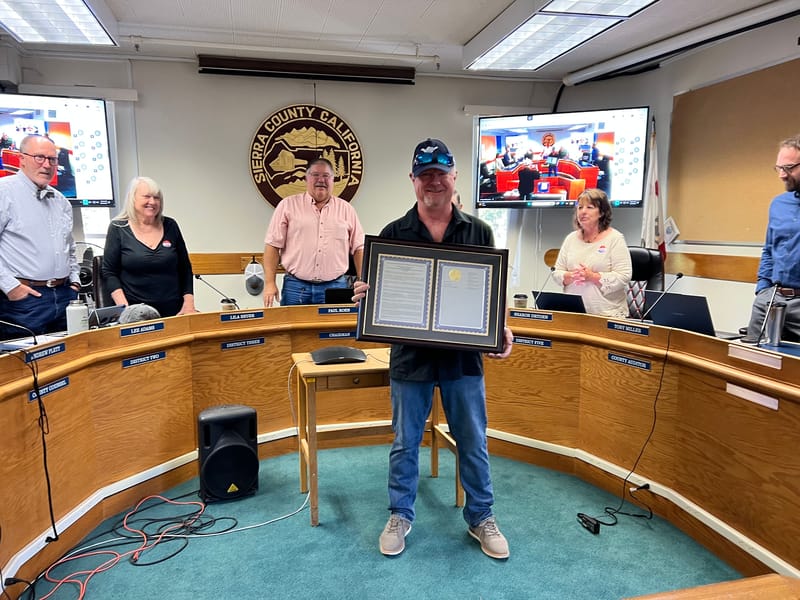 James Berardi holds the resolution of appreciation presented to him by the Sierra County Board of Supervisors.