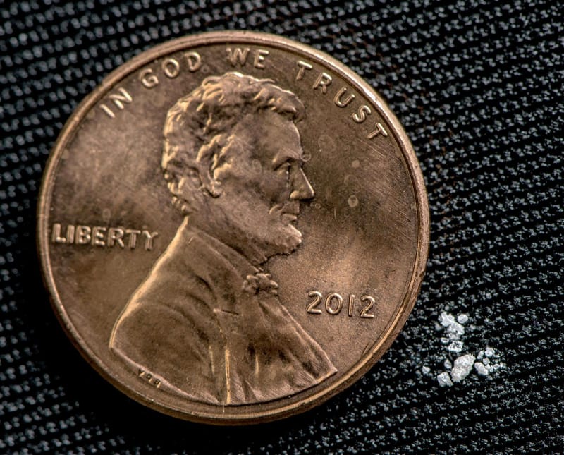 A 2 mg lethal dose of fentanyl, according to the US Drug Enforcement Agency, next to a penny.