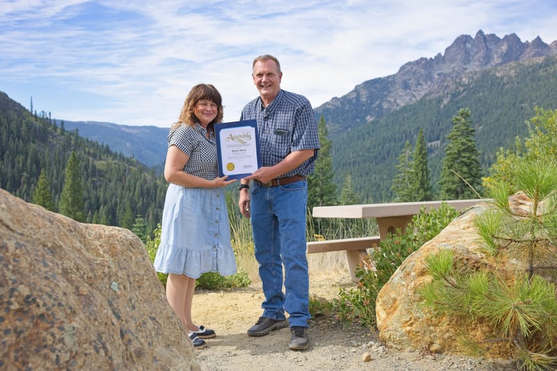 Yolanda Cookson presents a certificate of recognition to Bryan Davey.
